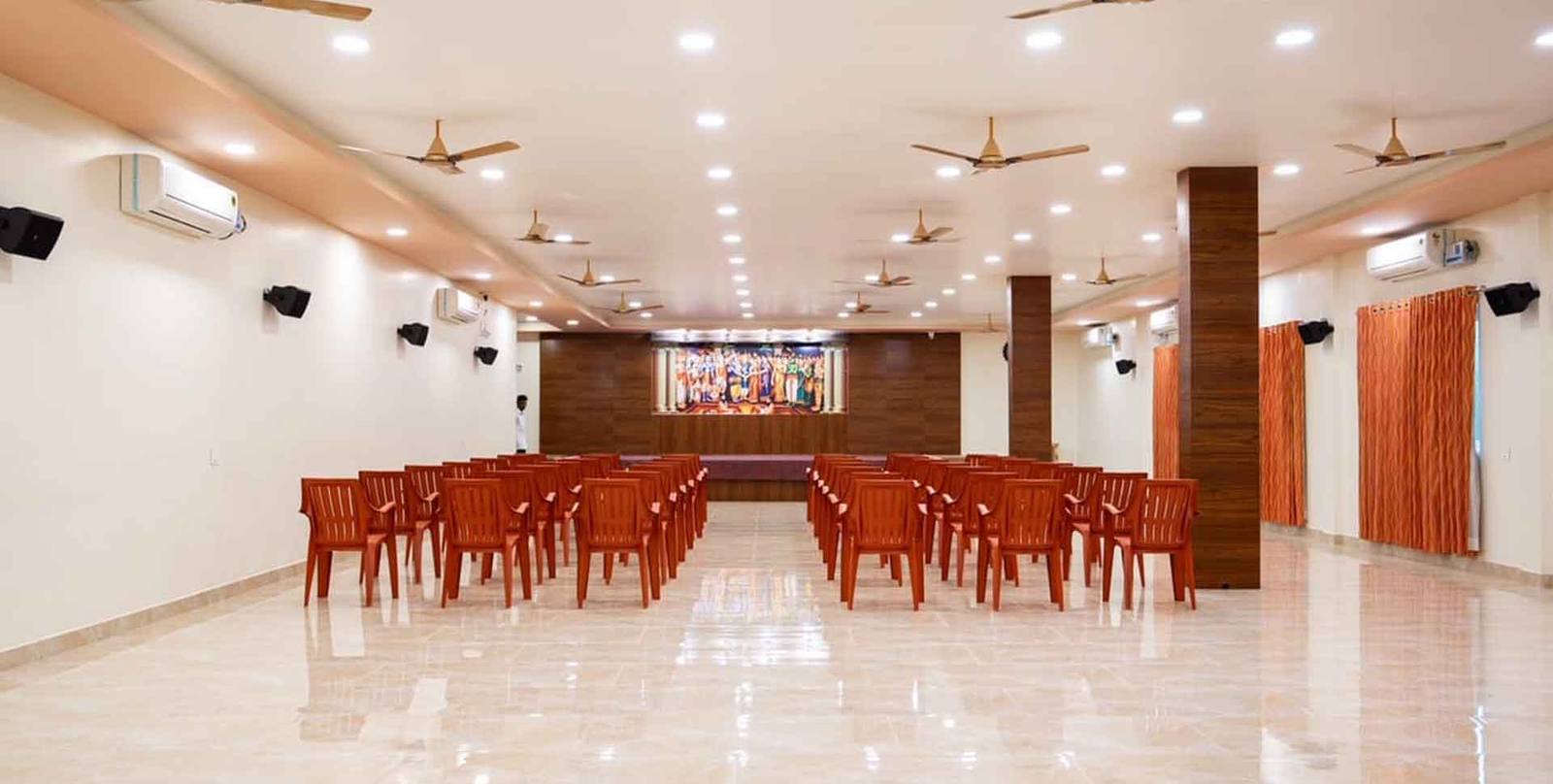 The air-conditioned conference hall at Divine Inn, set theatre-style facing the stage